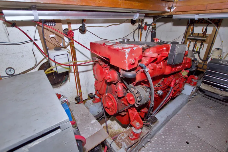 Slide: The Image of Engine room of 1984 Present Yachts 42 Sundeck with red machinery and wiring. - 81