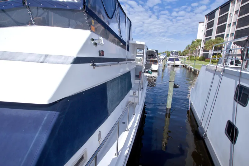 Slide: The Image of 1984 Present Yachts 42 Sundeck docked at marina under blue sky. - 9