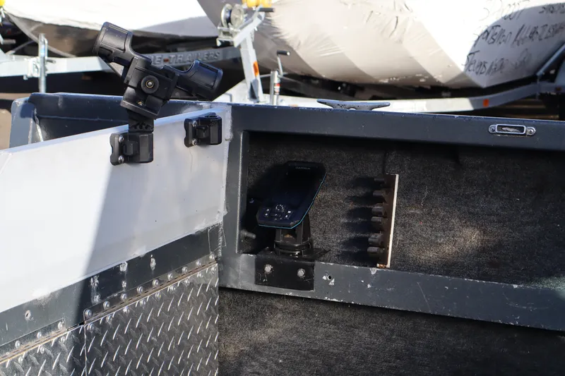 Slide: The Image of 1992 Alumaweld FV boat interior with mounted device and rod holders. - 10