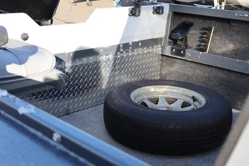 Slide: The Image of Interior of a 1992 Alumaweld FV boat with spare tire and diamond plate paneling. - 11