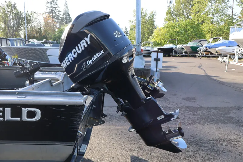 Slide: The Image of 1992 Alumaweld FV boat with Mercury OptiMax outboard motor in a marina setting. - 6