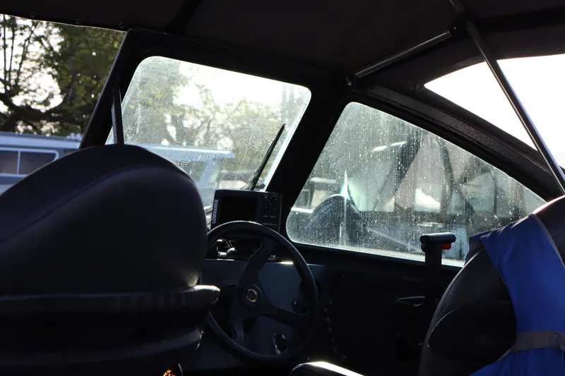 Slide: The Image of Interior of a 1992 Alumaweld FV boat with steering wheel and navigation equipment. - 8