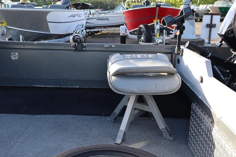 Slide: The Image of 1992 Alumaweld FV boat interior with gray seating and fishing rod holder. - 9