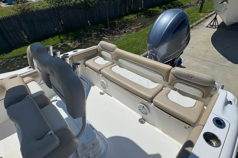 Slide: The Image of 2015 Key West 219 FS boat interior with seating and Yamaha outboard motor. - 11