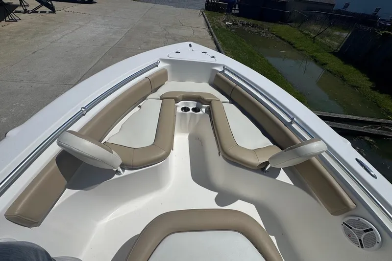 Slide: The Image of 2015 Key West 219 FS boat interior with beige seating and cup holders. - 12