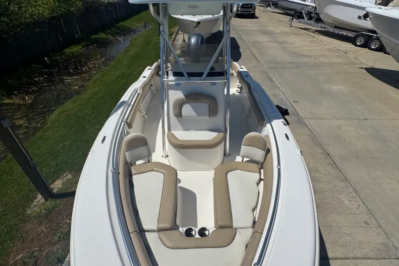 Slide: The Image of 2015 Key West 219 FS boat with spacious seating, docked on a sunny day. - 13