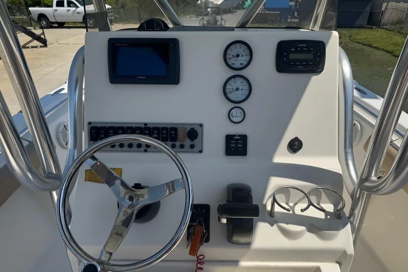 Slide: The Image of 2015 Key West 219 FS boat dashboard with steering wheel and gauges. - 18