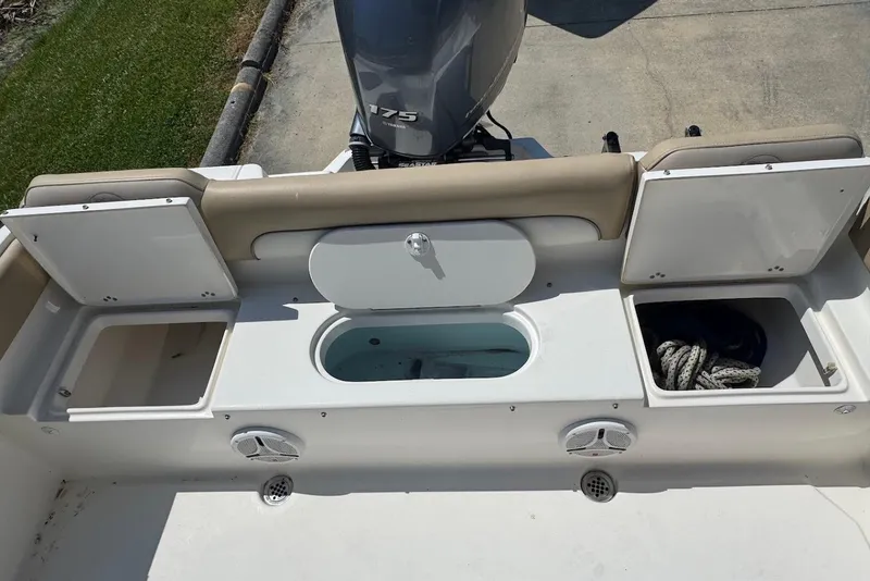 Slide: The Image of 2015 Key West 219 FS boat stern with storage compartments and Yamaha 175 engine. - 19