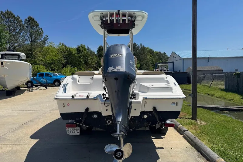 Slide: The Image of 2015 Key West 219 FS boat with Yamaha 175 engine, parked outdoors. - 8