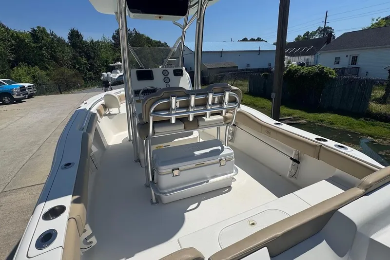 Slide: The Image of 2015 Key West 219 FS boat interior with seating and console, parked outdoors. - 9