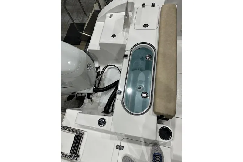 Slide: The Image of 2025 Sea Pro 240 Dual Console boat on trailer, parked in a lot under clear blue sky. - 11