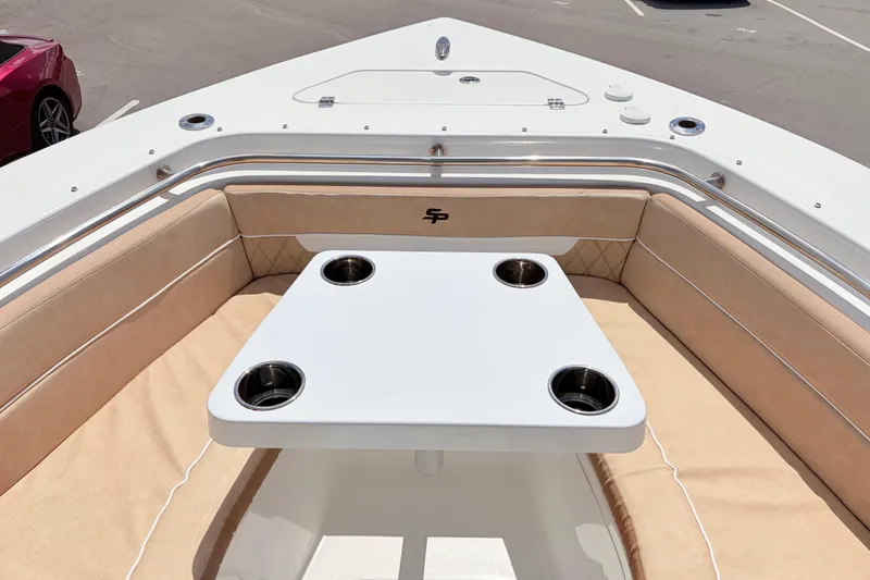 Slide: The Image of 2025 Sea Pro 240 Dual Console boat interior with cushioned seating and table. - 19