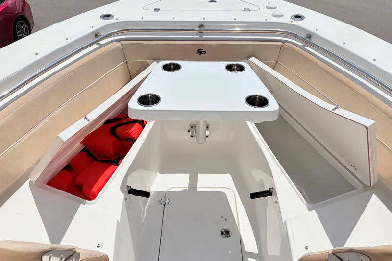 Slide: The Image of 2025 Sea Pro 240 Dual Console boat interior with seating, table, and storage compartments. - 20