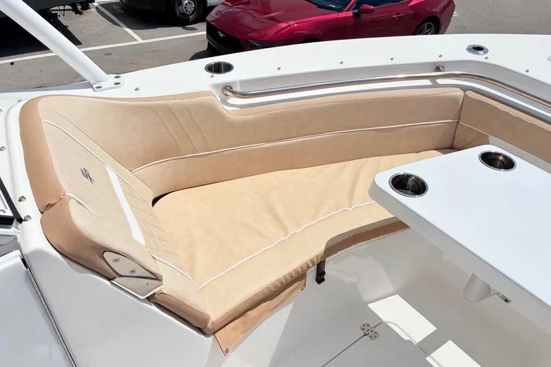 Slide: The Image of 2025 Sea Pro 240 Dual Console boat with beige seating and cup holders. - 21