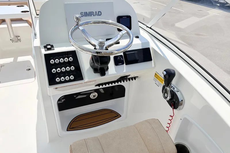 Slide: The Image of Helm of 2025 Sea Pro 240 Dual Console with Simrad electronics and modern controls. - 24