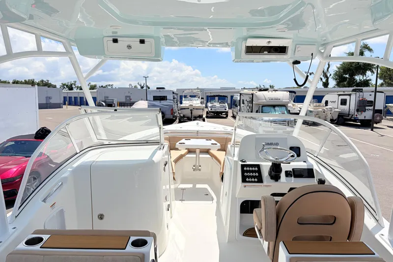 Slide: The Image of 2025 Sea Pro 240 Dual Console boat interior with helm and seating area. - 28