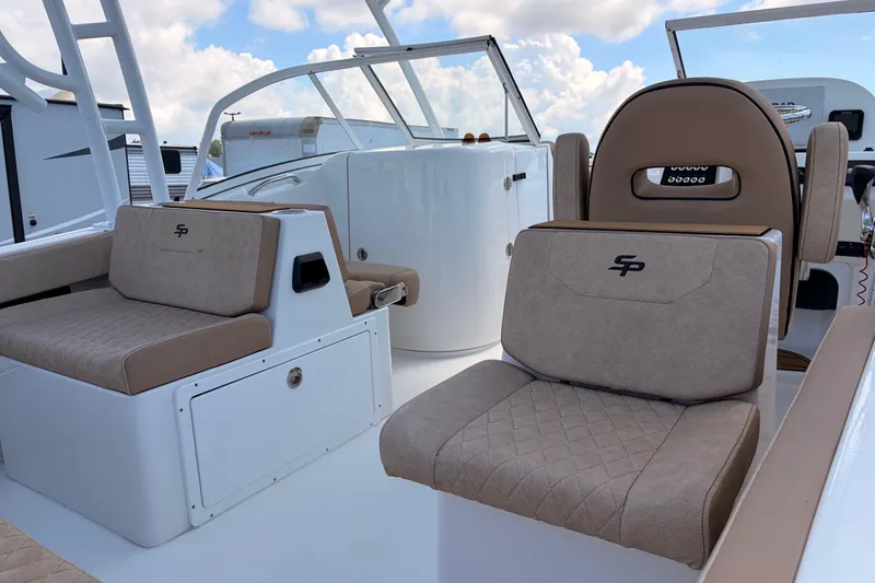 Slide: The Image of 2025 Sea Pro 240 Dual Console boat interior with beige seating and modern design. - 29