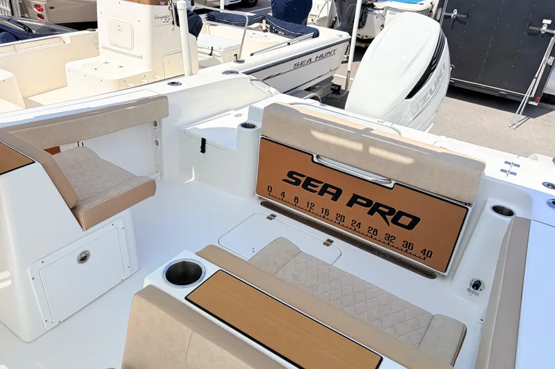 Slide: The Image of 2025 Sea Pro 240 Dual Console boat interior with seating and storage compartments. - 34