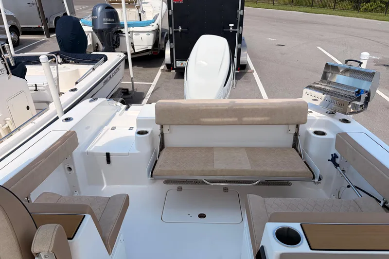 Slide: The Image of 2025 Sea Pro 240 Dual Console boat interior with seating and grill setup. - 36