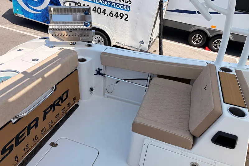 Slide: The Image of 2025 Sea Pro 240 Dual Console boat interior with seating and grill. - 37