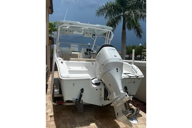 Slide: The Image of 2025 Sea Pro 240 Dual Console boat on trailer in parking lot. - 4