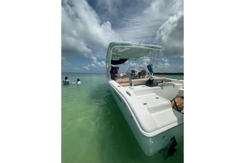 Slide: The Image of 2025 Sea Pro 240 Dual Console boat on trailer under clear blue sky. - 6
