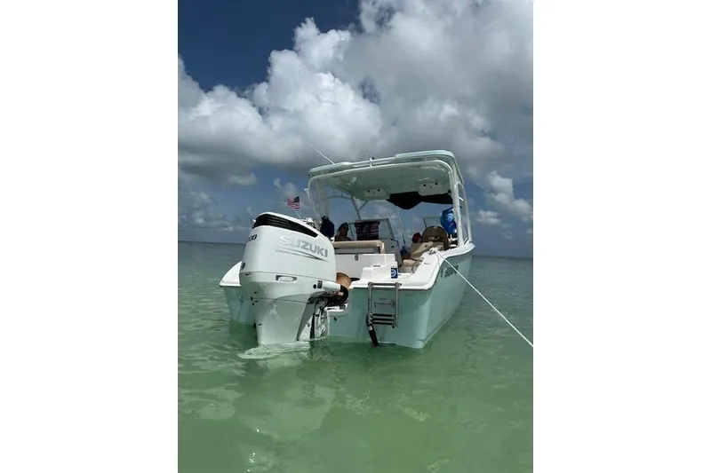 Slide: The Image of 2025 Sea Pro 240 Dual Console boat with Suzuki engine on trailer in parking lot. - 7