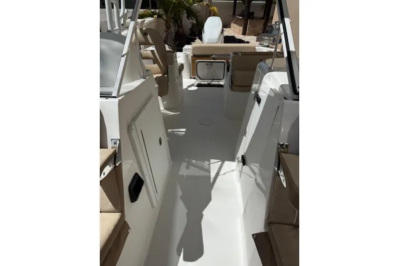 Slide: The Image of 2025 Sea Pro 240 Dual Console boat on a Float-On trailer in a parking lot. - 8