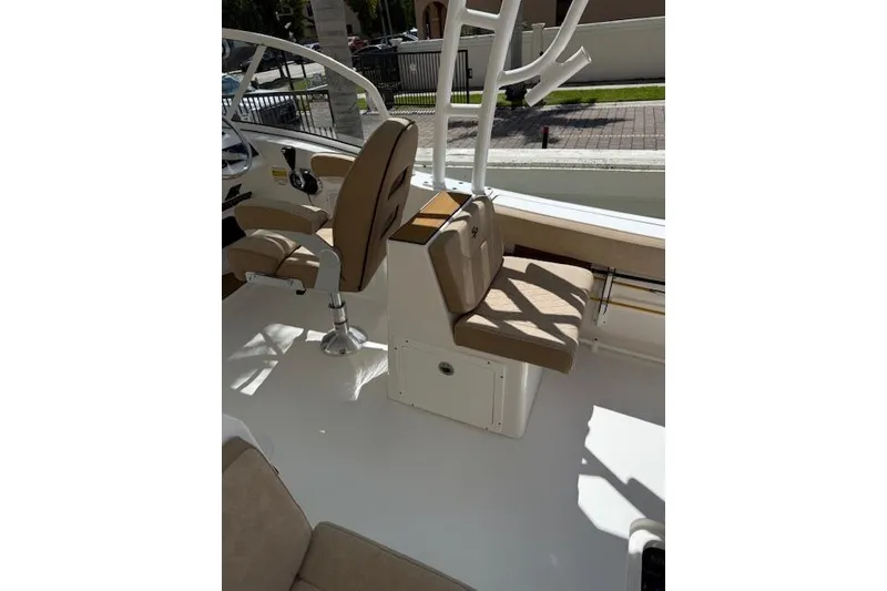 Slide: The Image of 2025 Sea Pro 240 Dual Console boat with outboard motor in a parking lot. - 9