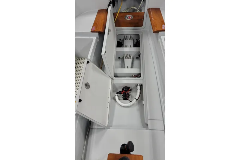 Slide: The Image of Interior view of a 2018 C.W. Hood 32 Daysailer, showcasing storage compartments and wooden accents. - 17