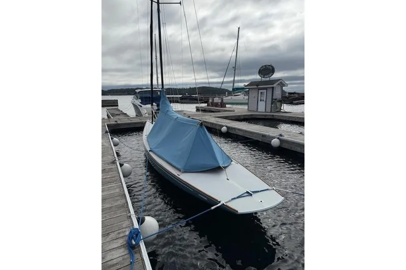 Slide: The Image of 2018 C.W. Hood 32 Daysailer docked with blue cover, overcast sky. - 2