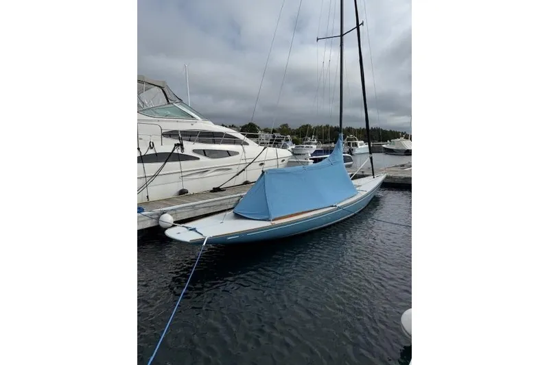 Slide: The Image of 2018 C.W. Hood 32 Daysailer docked with blue cover, surrounded by other boats. - 3