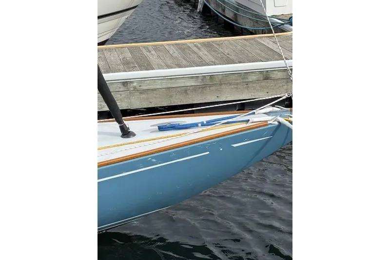 Slide: The Image of Blue C.W. Hood 32 Daysailer, 2018 model, docked at a wooden pier. - 4
