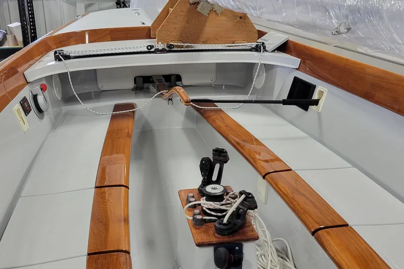 Slide: The Image of Interior view of a 2018 C.W. Hood 32 Daysailer, featuring polished wooden trim and sailing equipment. - 7