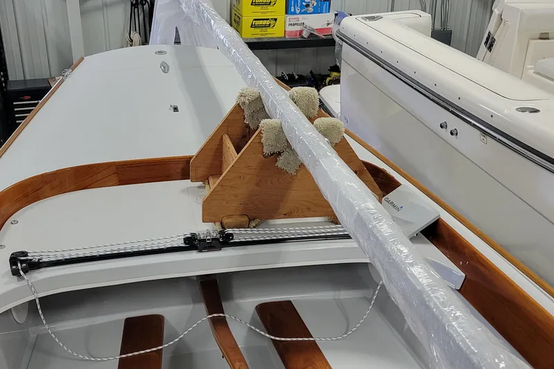 Slide: The Image of 2018 C.W. Hood 32 Daysailer in storage, showcasing deck and wooden details. - 9
