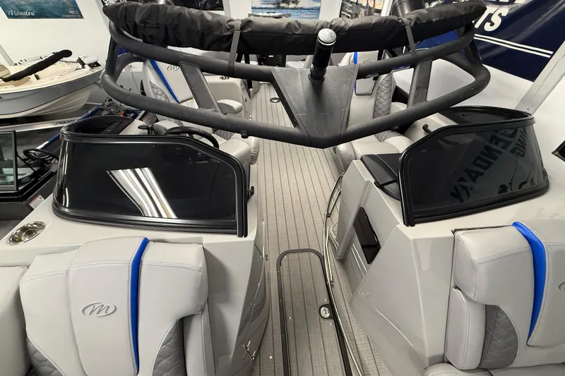 Slide: The Image of 2026 Manitou 25 LX RFW boat interior with modern seating and sleek design. - 15