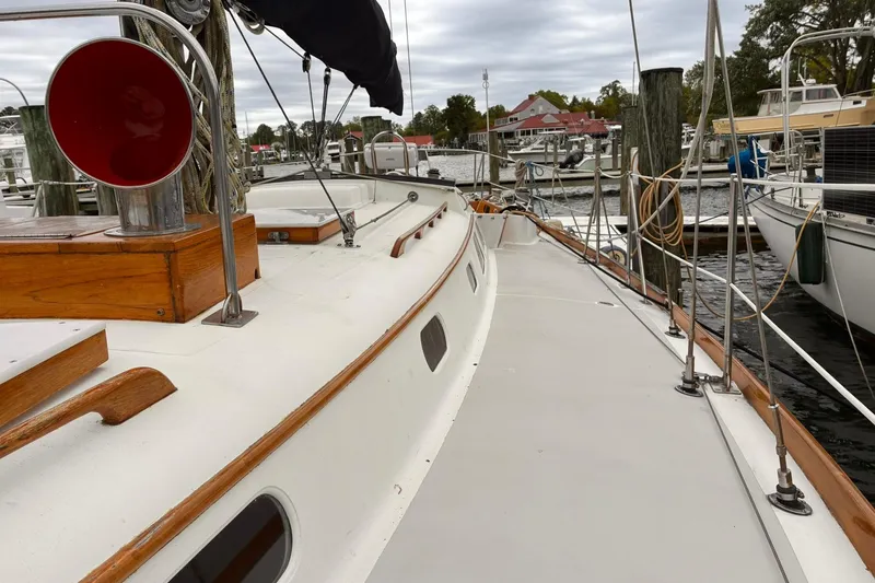 Slide: The Image of 1980 Hinckley Bermuda 40 MKIII sailboat docked at a marina, showcasing its classic design. - 11