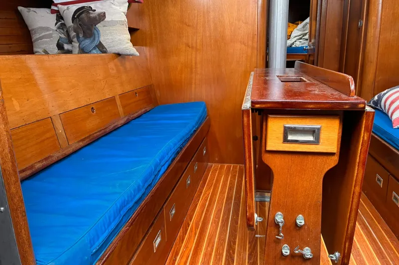 Slide: The Image of Interior of 1980 Hinckley Bermuda 40 MKIII with wooden cabinetry and blue cushions. - 19