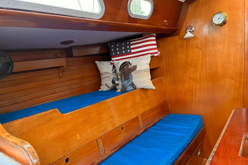 Slide: The Image of Cozy cabin interior of 1980 Hinckley Bermuda 40 MKIII with blue cushions and decorative pillows. - 20