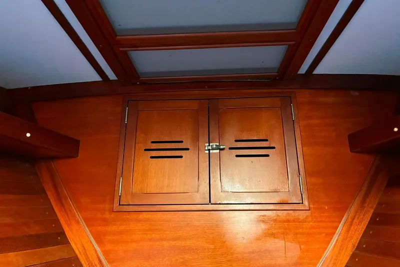 Slide: The Image of Wooden interior of 1980 Hinckley Bermuda 40 MKIII sailboat with vented cabinet doors. - 29
