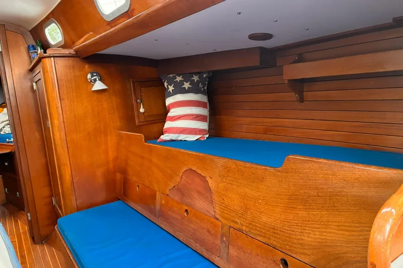Slide: The Image of Interior of 1980 Hinckley Bermuda 40 MKIII sailboat with wooden finish and blue cushions. - 32