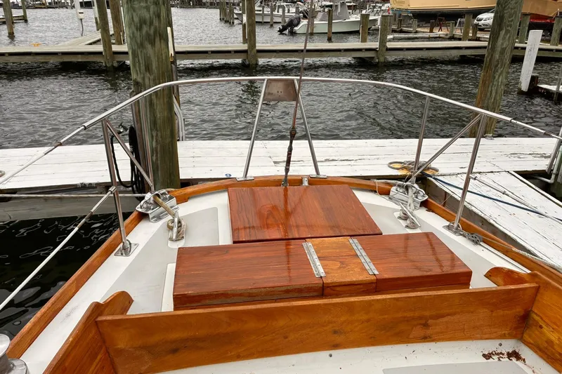 Slide: The Image of Hinckley Bermuda 40 MKIII sailboat, 1980 model, docked with polished wooden deck details. - 5