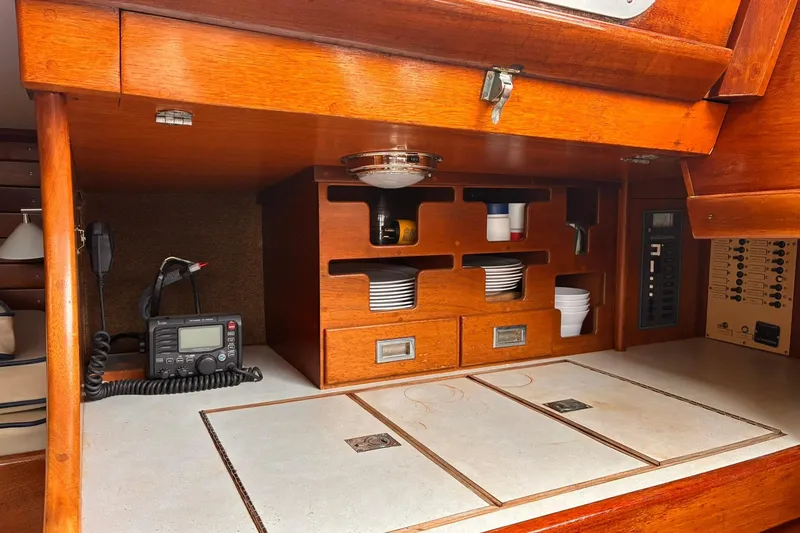 Slide: The Image of Interior of 1980 Hinckley Bermuda 40 MKIII yacht galley with wooden cabinetry and radio equipment. - 18