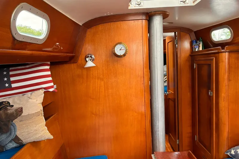 Slide: The Image of Interior of 1980 Hinckley Bermuda 40 MKIII sailboat with wooden paneling and nautical decor. - 22