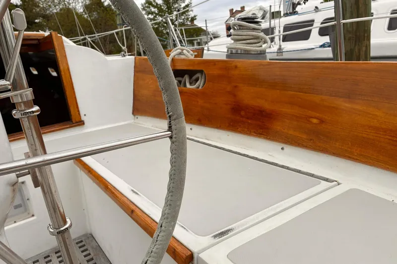 Slide: The Image of Cockpit of 1980 Hinckley Bermuda 40 MKIII sailboat with wooden trim and steering wheel. - 5