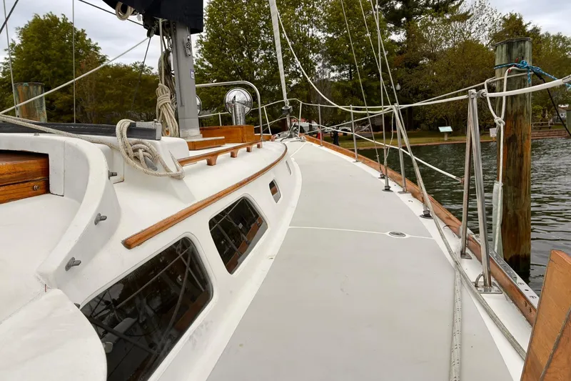 Slide: The Image of 1980 Hinckley Bermuda 40 MKIII sailboat deck with ropes and wooden accents. - 7