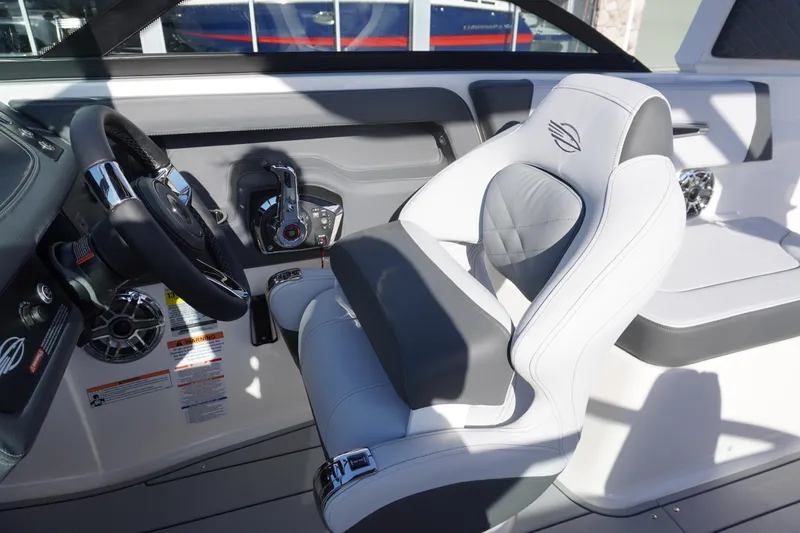 Slide: The Image of 2026 Chaparral 247 SSX boat interior with sleek steering wheel and luxurious seating. - 14