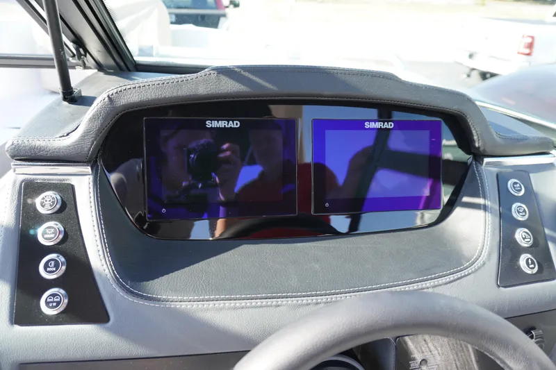 Slide: The Image of 2026 Chaparral 247 SSX dashboard featuring dual Simrad displays and control buttons. - 16