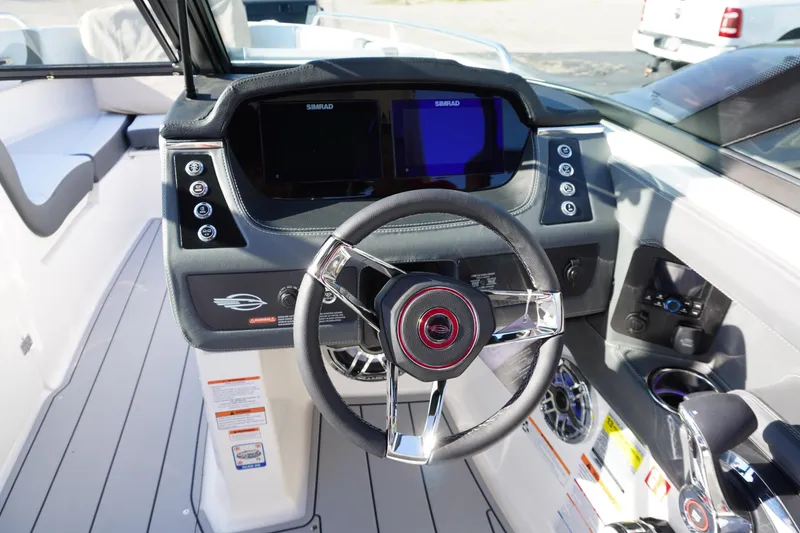 Slide: The Image of 2026 Chaparral 247 SSX boat dashboard with steering wheel and control panel. - 17