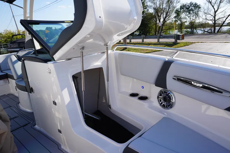 Slide: The Image of 2026 Chaparral 247 SSX boat interior with open storage compartment and sleek design. - 23